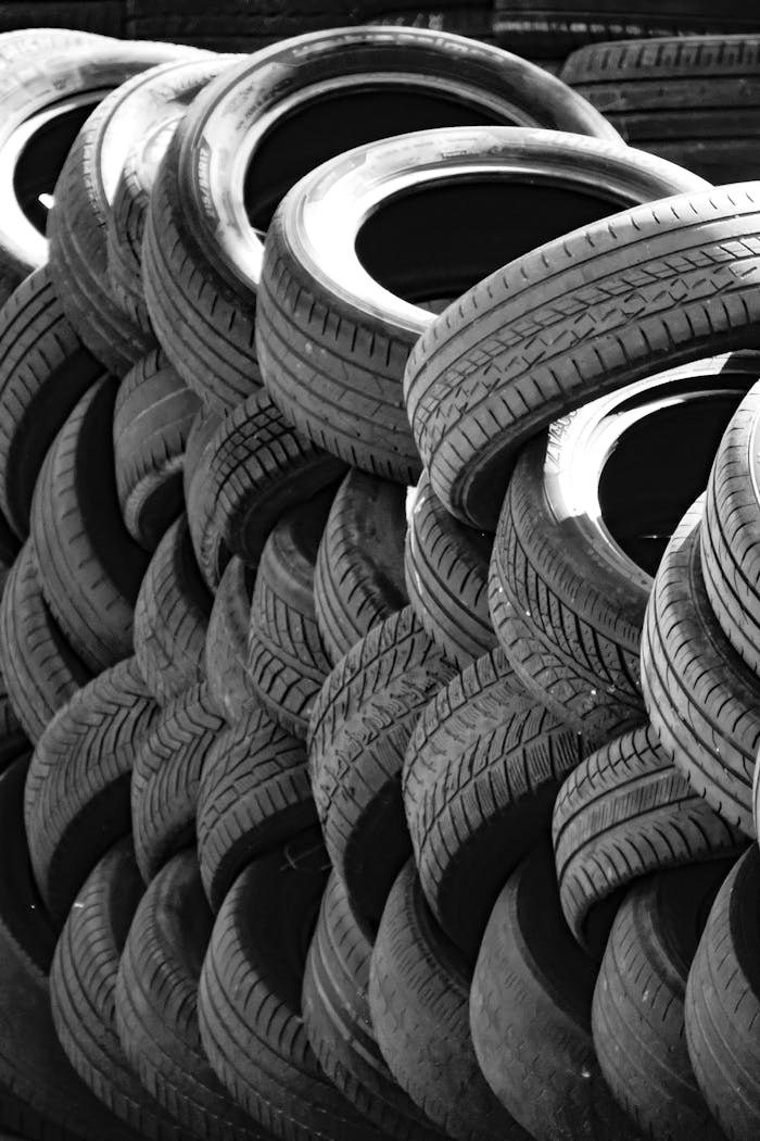 services-01 Artistic black and white image of a stack of used tires outdoors. Perfect for recycling concepts.